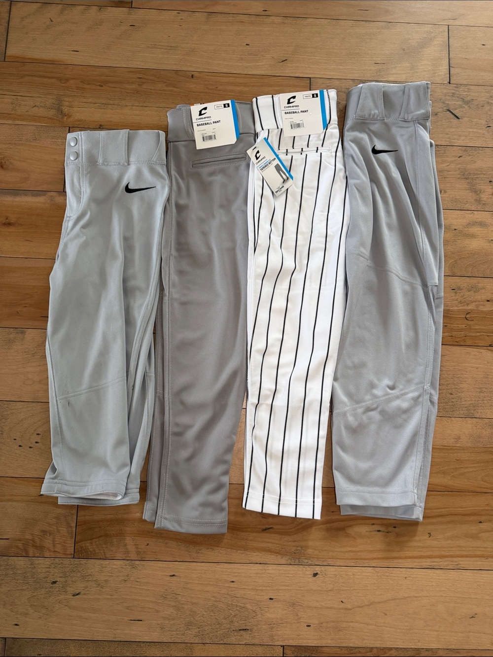 Four pair Nike/Champro boys baseball pants; 2 pair NWT; size small and medium